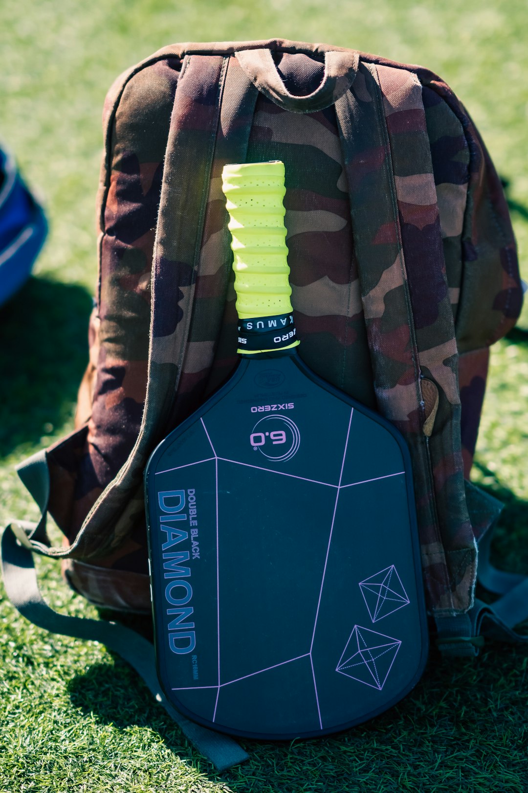 a-back-pack-sitting-on-top-of-a-green-field-fmytwwyozro